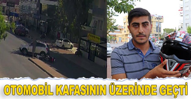 Otomobil kafasının üzerinde geçti